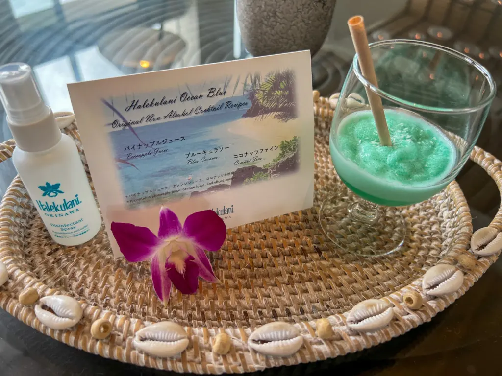 Welcome drink pineapple juice and Halekulani Okinawa disinfectant spray on a tray